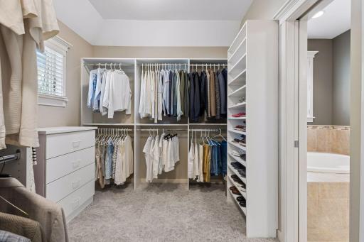 Keep your entire wardrobe organized in the large walk-in closet (14'3" x 8'7"). The built-in organizational system includes hanging racks, a dresser, shoe storage, & cubies. The room includes a pan ceiling & window to fill it with natural light.