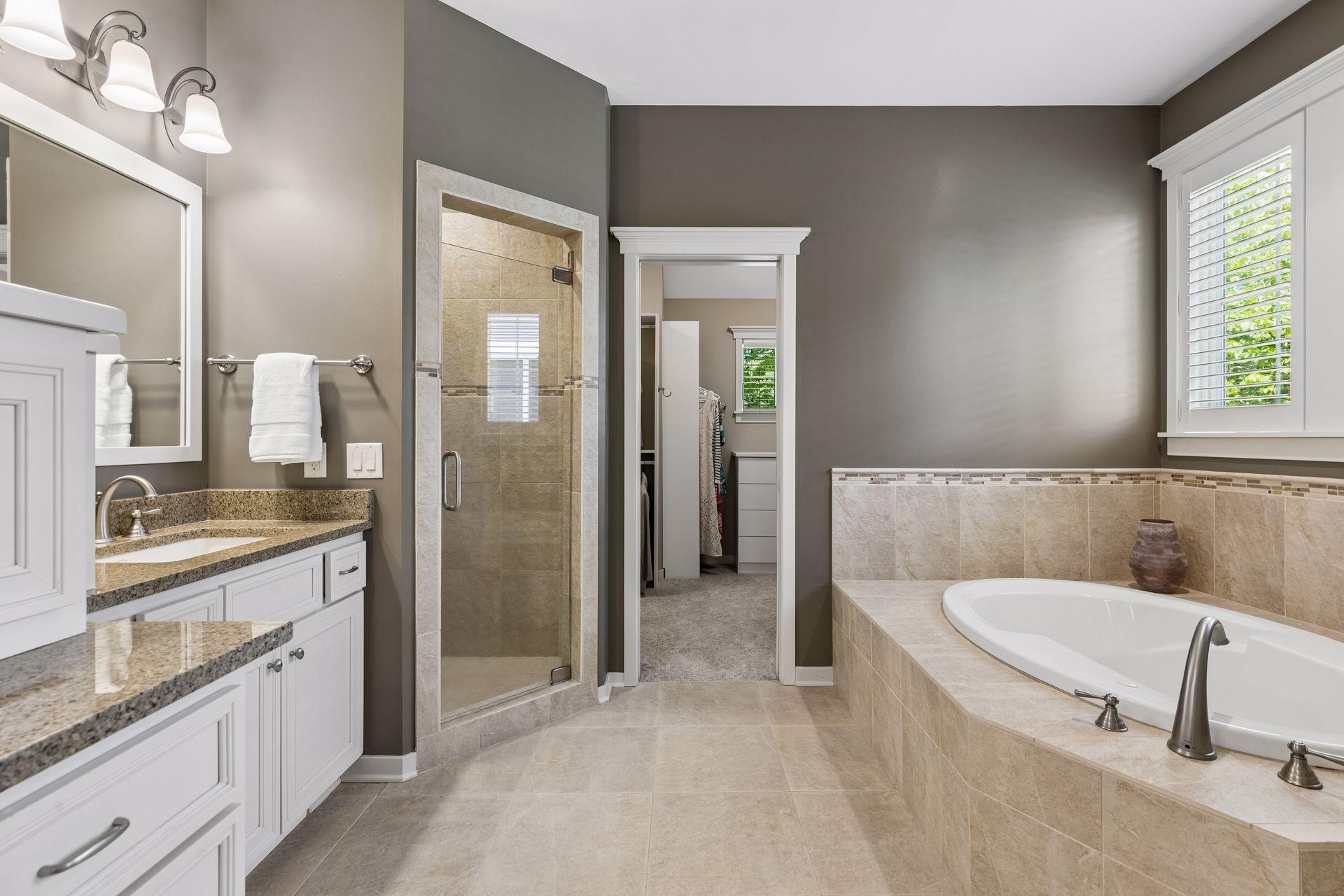 Relax in the deep soaking tub or in the easy step-in shower w/a glass door & a convenient bench. Dressing is a breeze in the large walk-in closet.