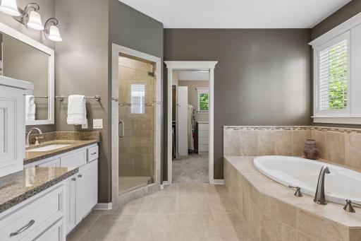Relax in the deep soaking tub or in the easy step-in shower w/a glass door & a convenient bench. Dressing is a breeze in the large walk-in closet.