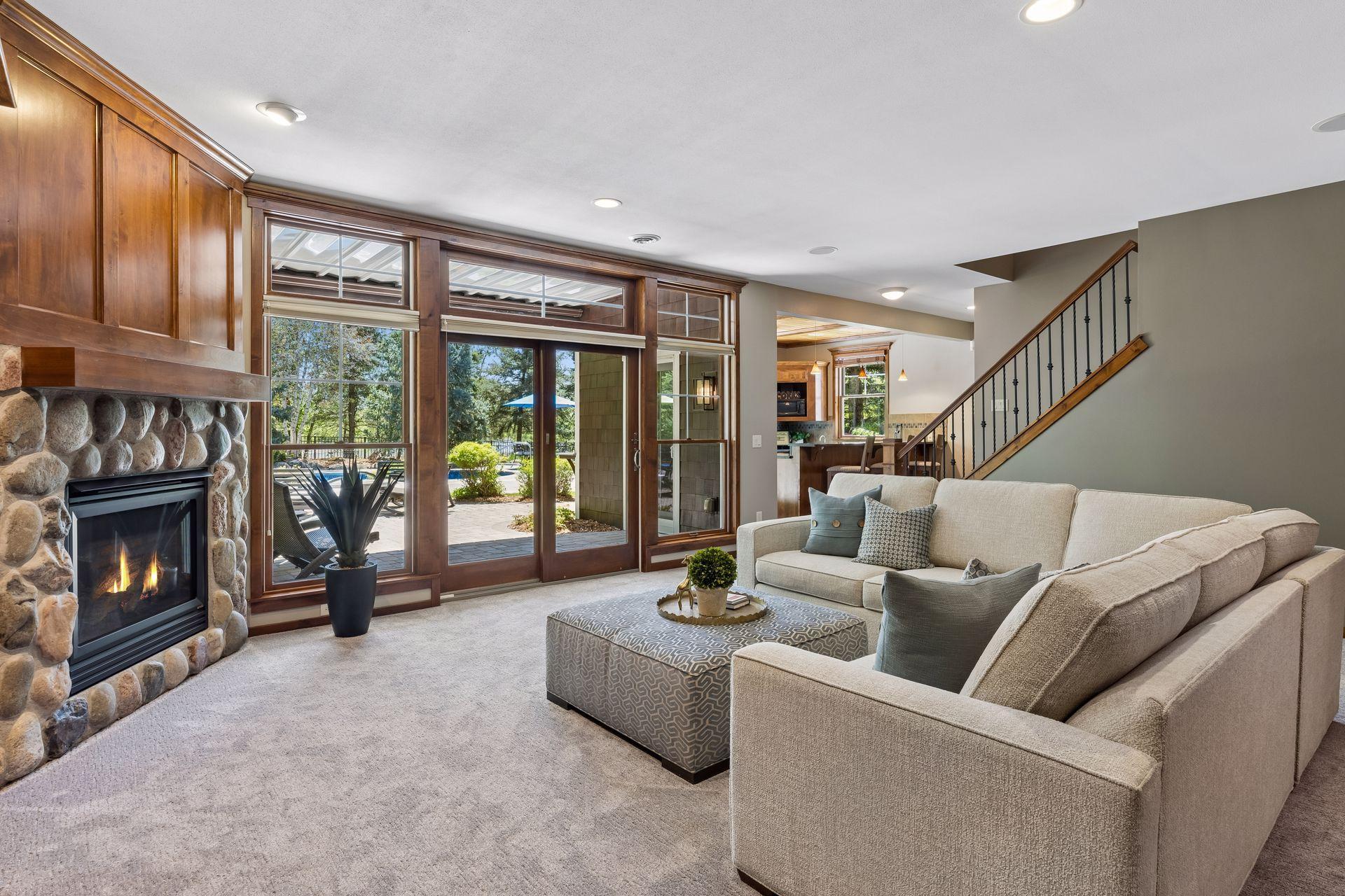 This view highlights the lower-level layout and the beautiful backyard oasis.