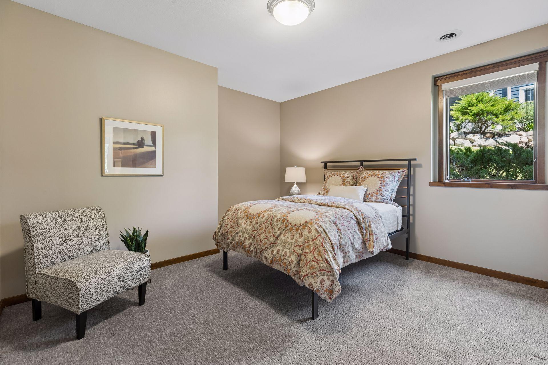 Bedroom 4 in the lower-level includes a large window filling the room with natural light and a large closet with an organizational system. It shared the Jack & Jill bathroom.