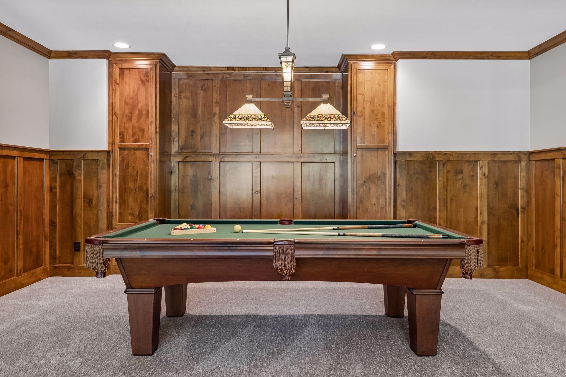 Let the games begin in your own pool/game room. It features elder wood wainscoting & a built-in bench with storage, crown molding & a decorative pool table light fixture.