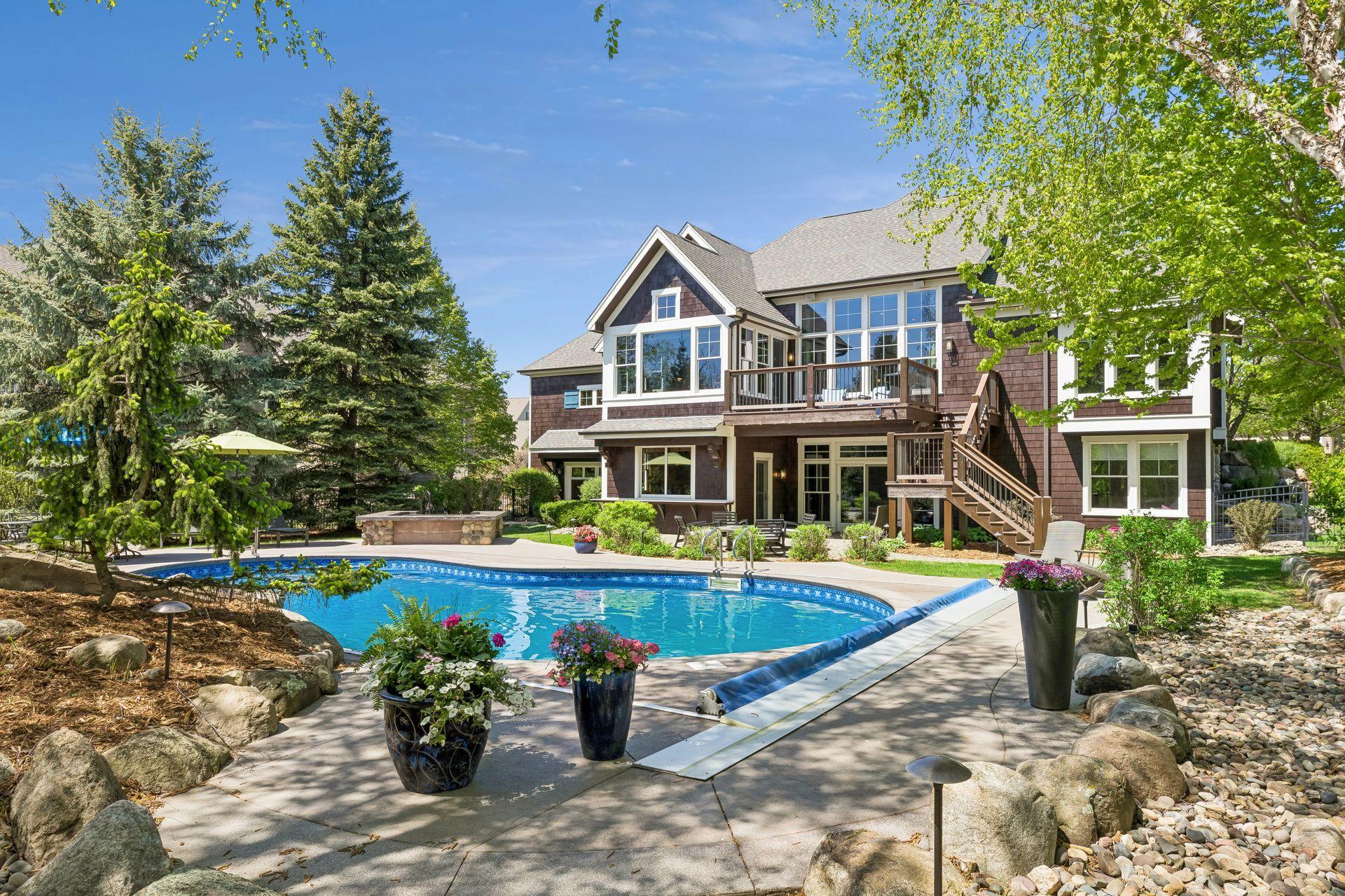 Your own private, wooded resort-like backyard! It features a heated saltwater pool, built-in hot tub, stone waterfall feature, professional landscaping, a large TimerTech deck (2025) & paver patio w/firepit area.