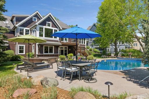 Lots of space around the pool for tables & umbrellas. Feel secluded in the wooded backyard with mature trees & beautiful professional landscaping.
