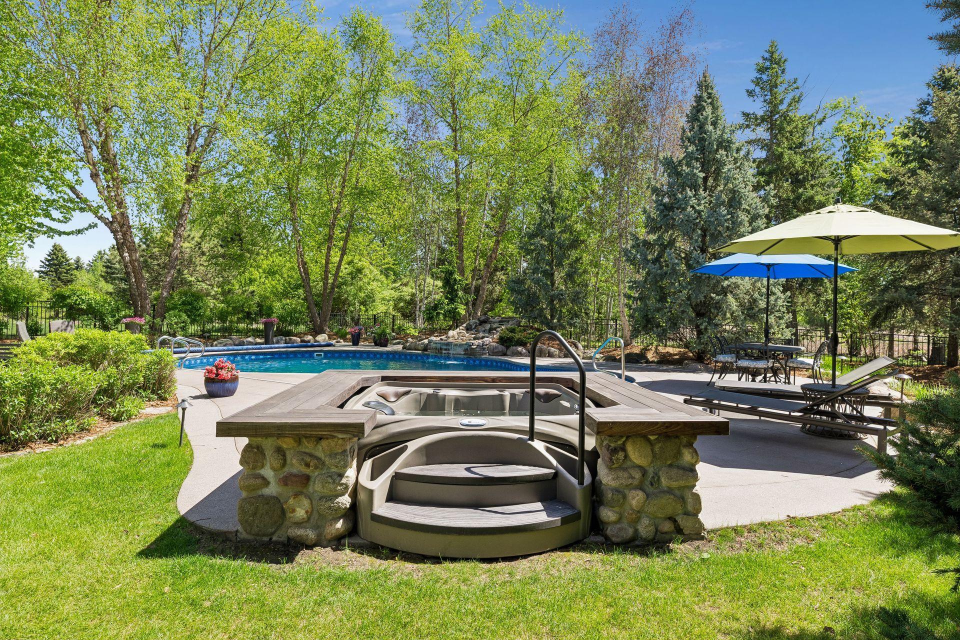The newer built-in hot tub (2022) holds 4-6 people. It adds to the resort-like feel of the backyard oasis.