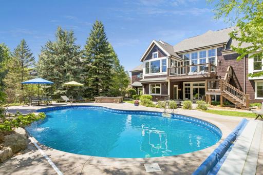 Another view of the stunning backyard oasis. The far left of the house features a sub-garage (21'3" x 27'3") providing easy access for all your yard tools and toys. The garage includes heated floors & built-in storage.