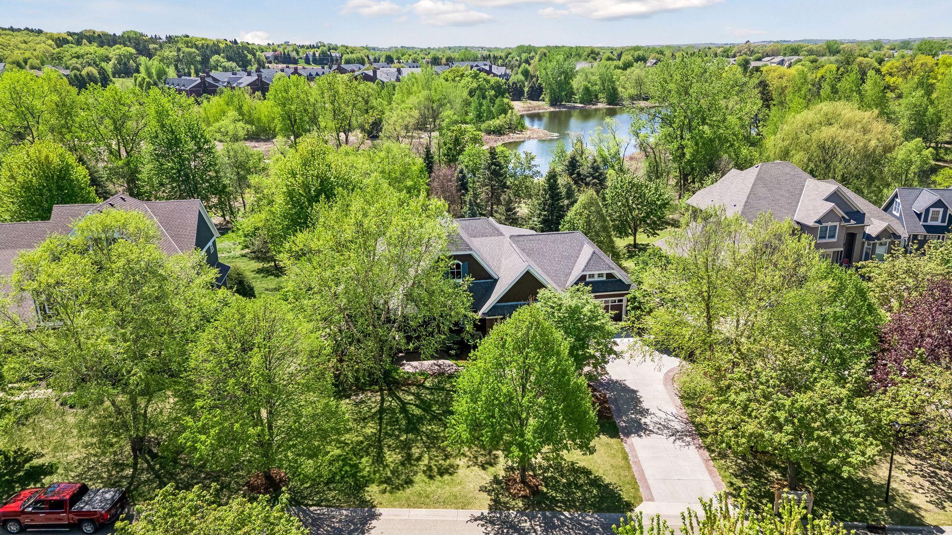 This home is located on a beautiful private wooded lot that backs up to a walking path & Fish Lake & wetlands. Key exterior features: freshly stained cedar shakes - 2026, new TimberTech front porch & exterior lights - 2025, & roof - 2022.