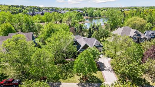 This home is located on a beautiful private wooded lot that backs up to a walking path & Fish Lake & wetlands. Key exterior features: freshly stained cedar shakes - 2026, new TimberTech front porch & exterior lights - 2025, & roof - 2022.