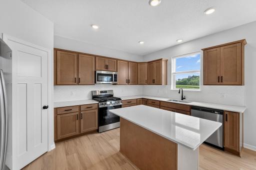 Kitchen includes - walk-in pantry, GE Stainless Steel appliances and ceramic tile backsplash.