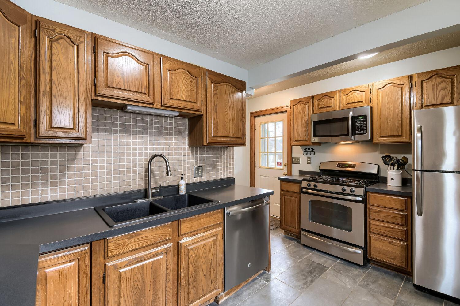 Gas stove, dishwasher, and tiled backsplash