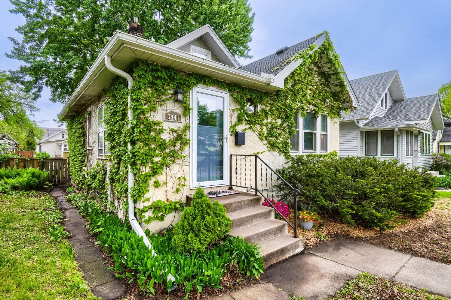 Stucco exterior with gorgeous woodsy vines.