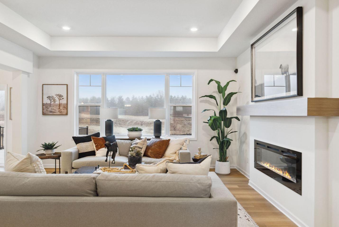 The family room is spacious and has large windows to allow natural light to pour into the home. Photo of model home, colors and options may vary. See listing agent for details.
