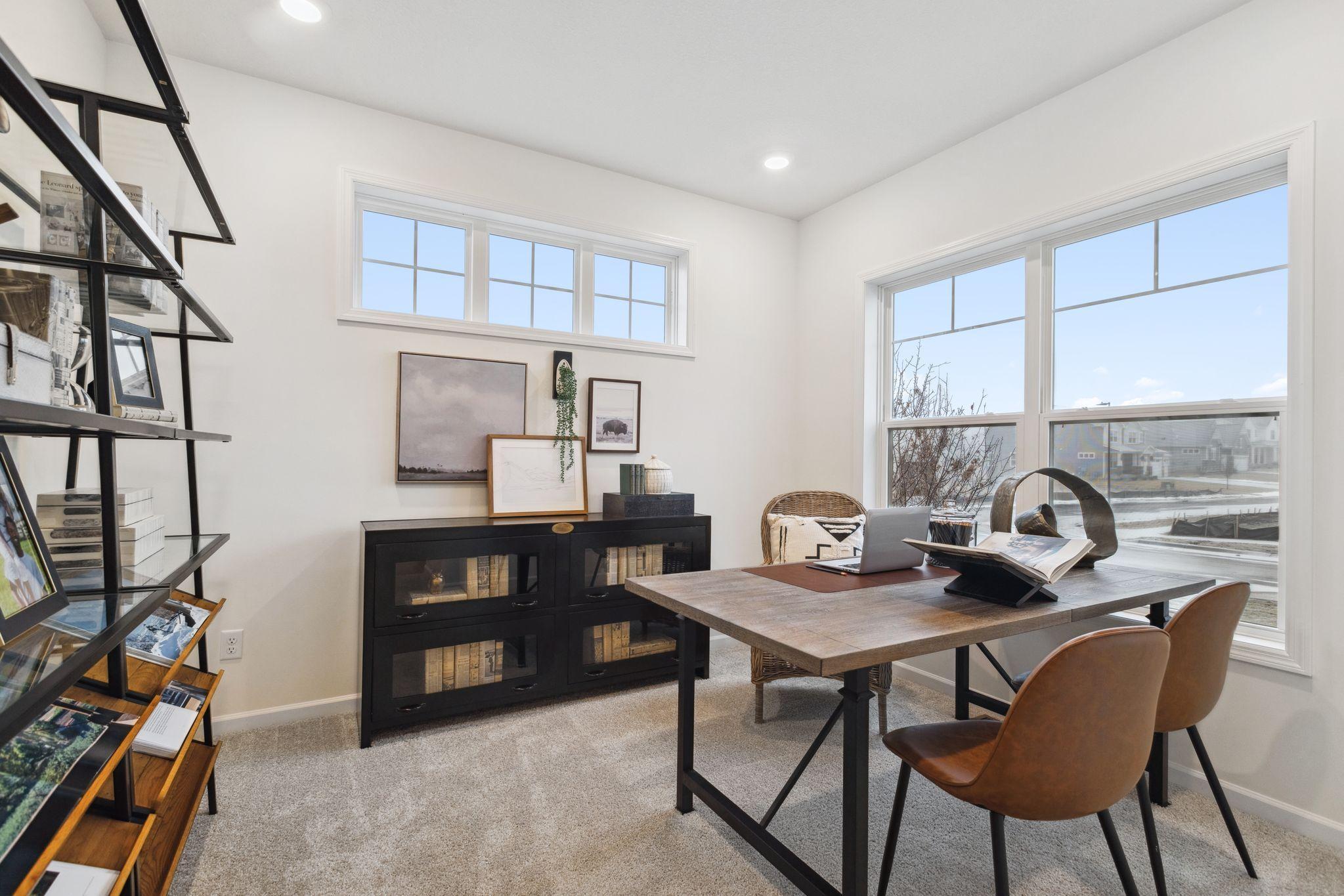 The den at the front of the home makes for a perfect office space, or an additional sitting area on the main level. Photo of model home, colors and options may vary. See listing agent for details.