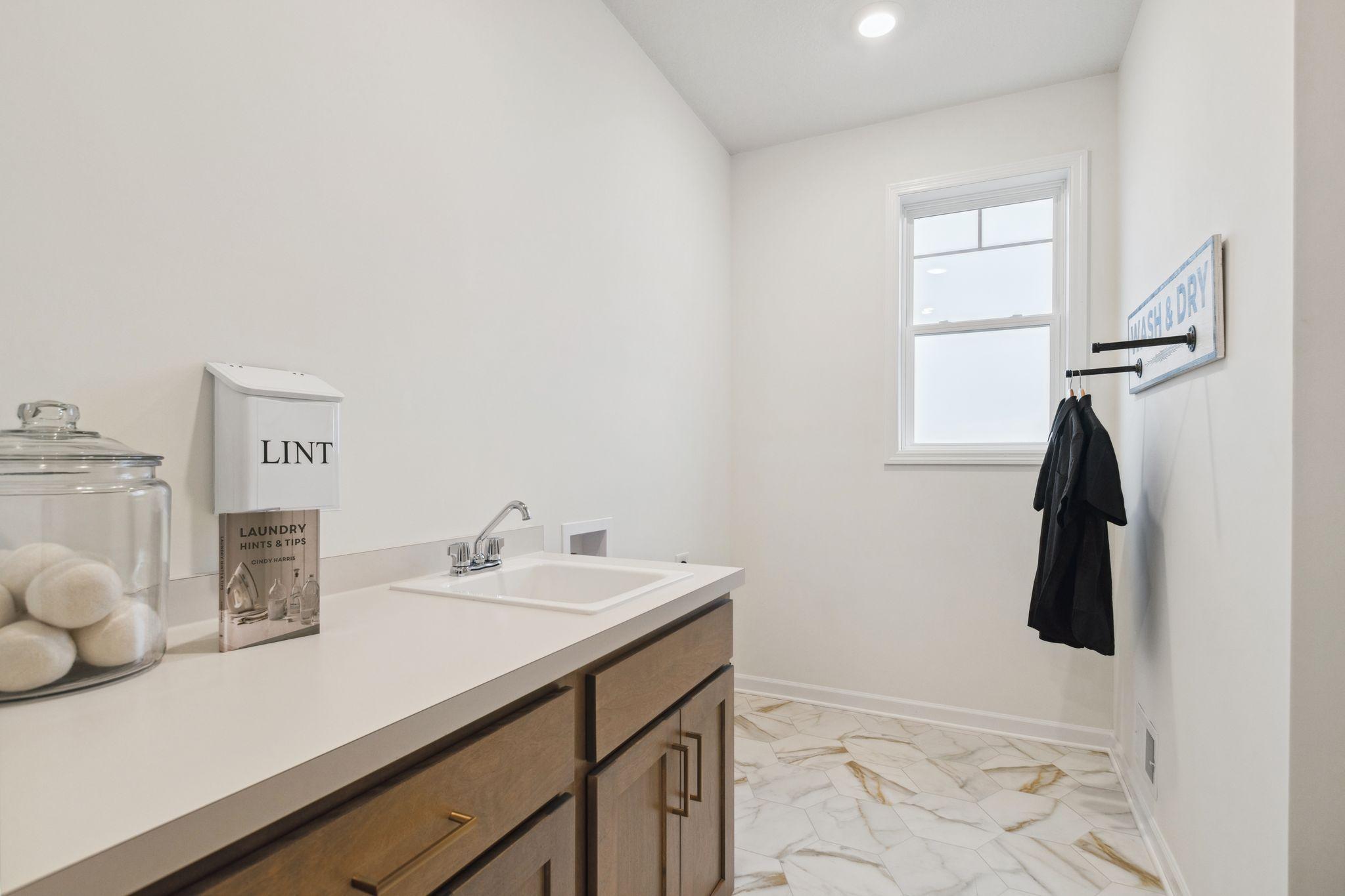 The convenience of main level laundry! Photo of model home, colors and options may vary. See listing agent for details.
