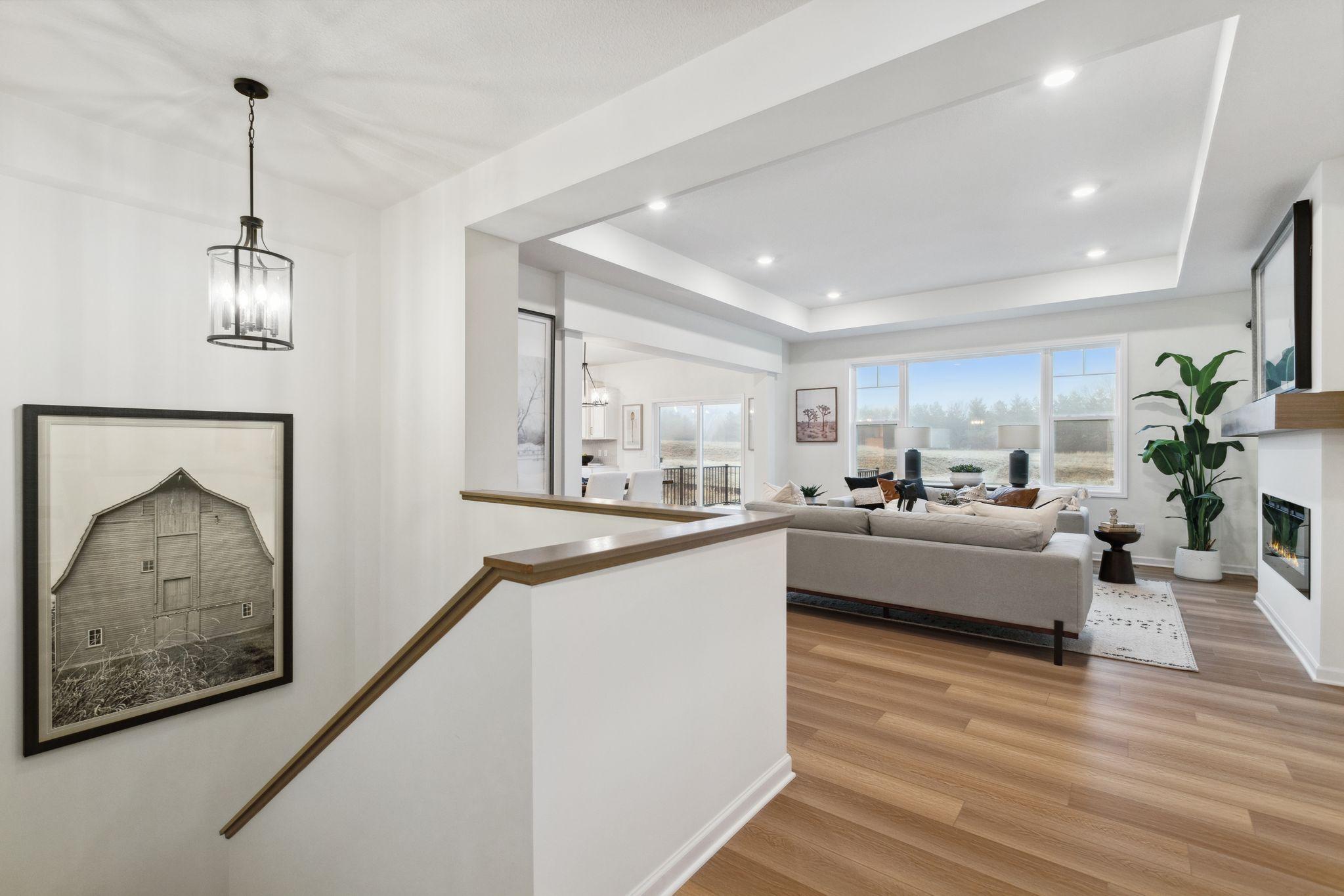 The entry flows into the family room and to the spacious stairway leading to the finished lower level. Photo of model home, colors and options may vary. See listing agent for details.