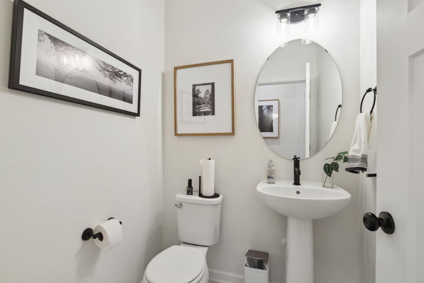The powder bath provides that necessary second main floor bathroom, conveniently located off the mudroom. Photo of model home, colors and options may vary. See listing agent for details.