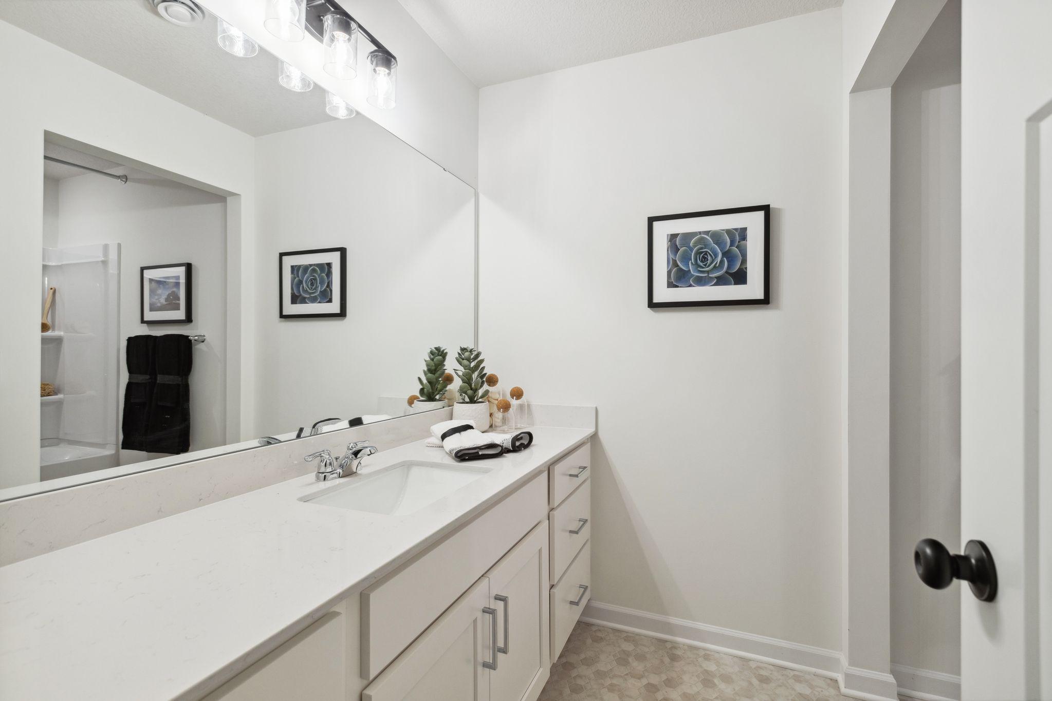 The lower level bath is stunning and spacious! It is ideal for servicing the lower level rec room and two lower level bedrooms. Photo of model home, colors and options may vary. See listing agent for details.