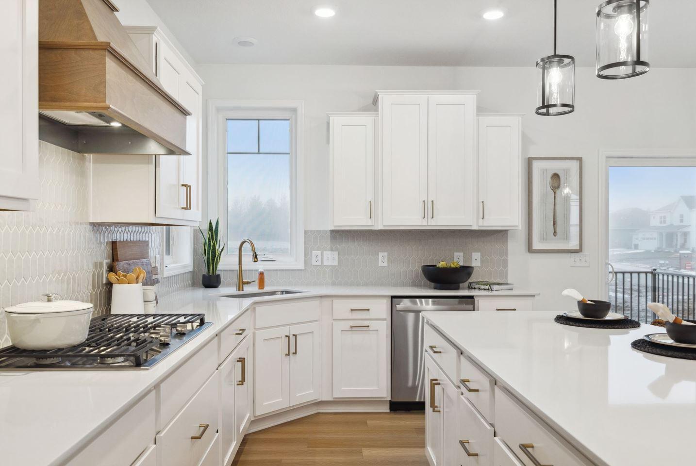 Plenty of countertop and storage space in this gourmet kitchen! The sink location is ideal as well, not taking up island space where guests gather. Photo of model home, colors and options may vary. See listing agent for details.