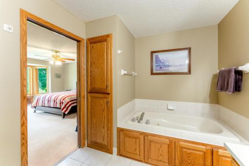 Owner's bathroom with soaking tub and more storage.