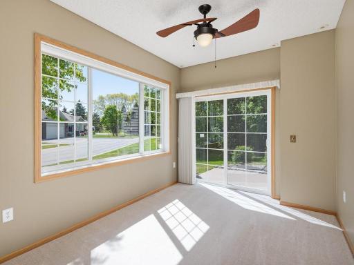Sunroom opens to patio with wonderful yard space and wooded view.