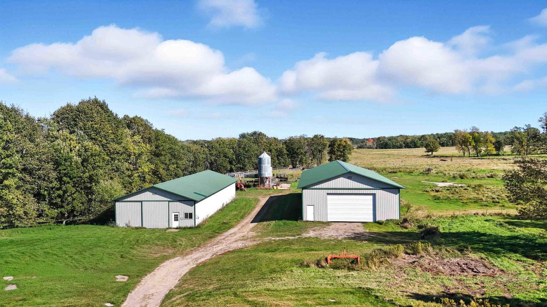 Horse barn with box stalls, wash bay, bathroom and office, maching shed on right