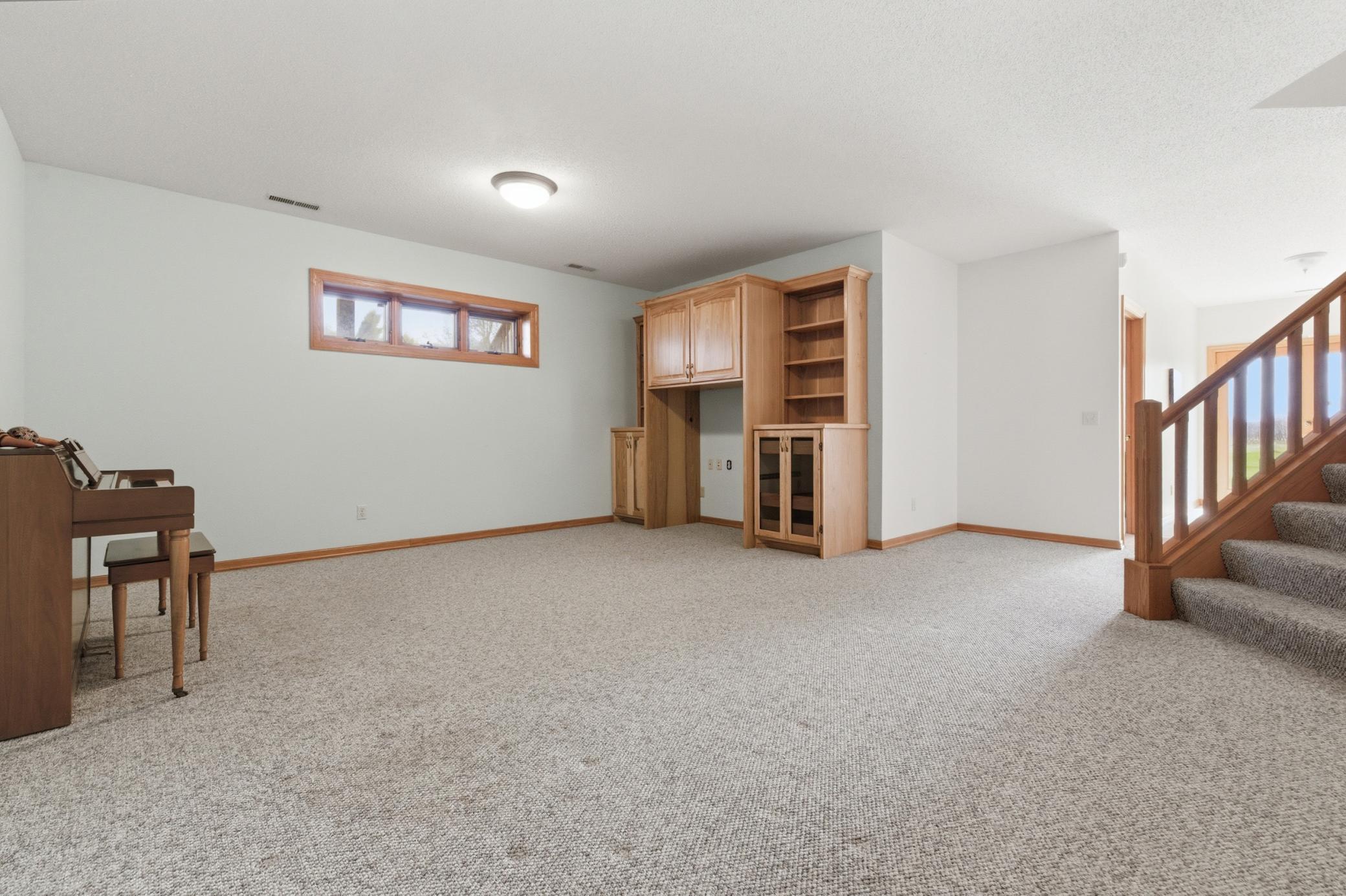 large lower level framily room with custum cabinetry