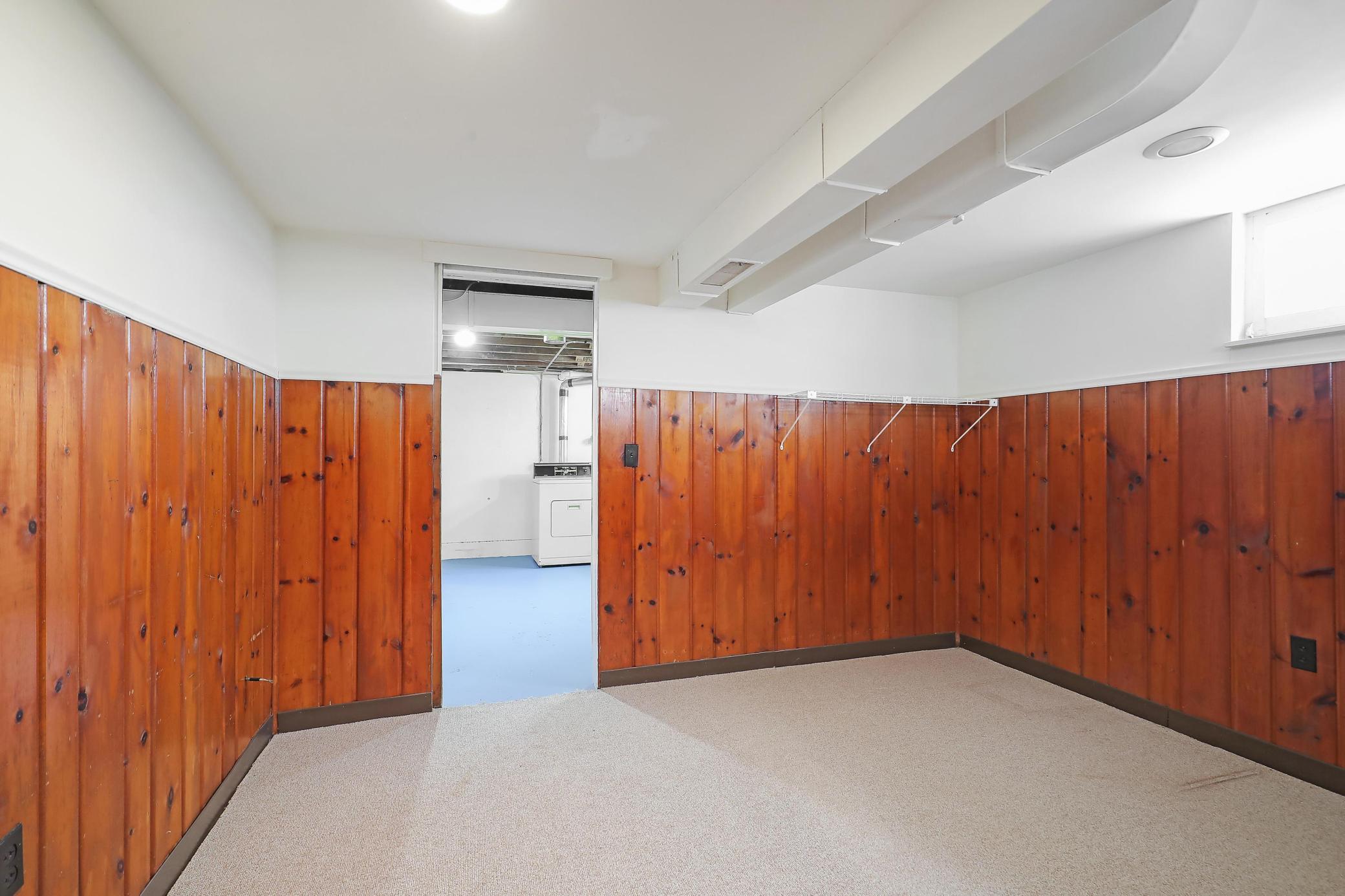 Bonus room features genuine wood panels.