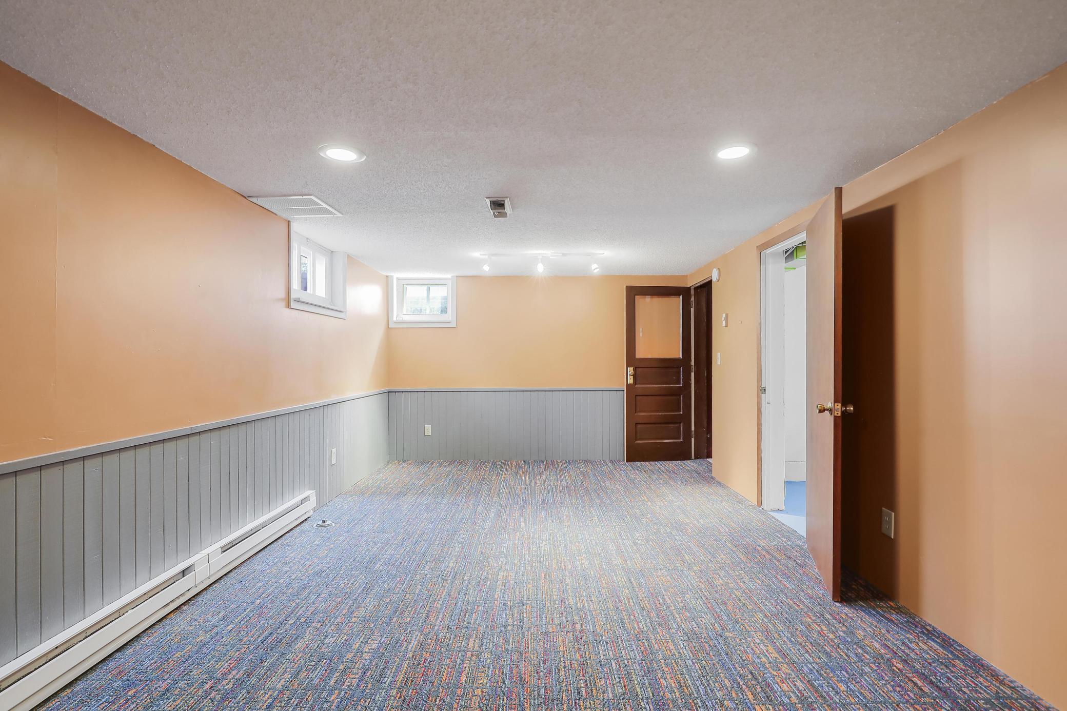 Family/rec room features nice lighting, custom painting with coordinating carpet and electric baseboard heating.