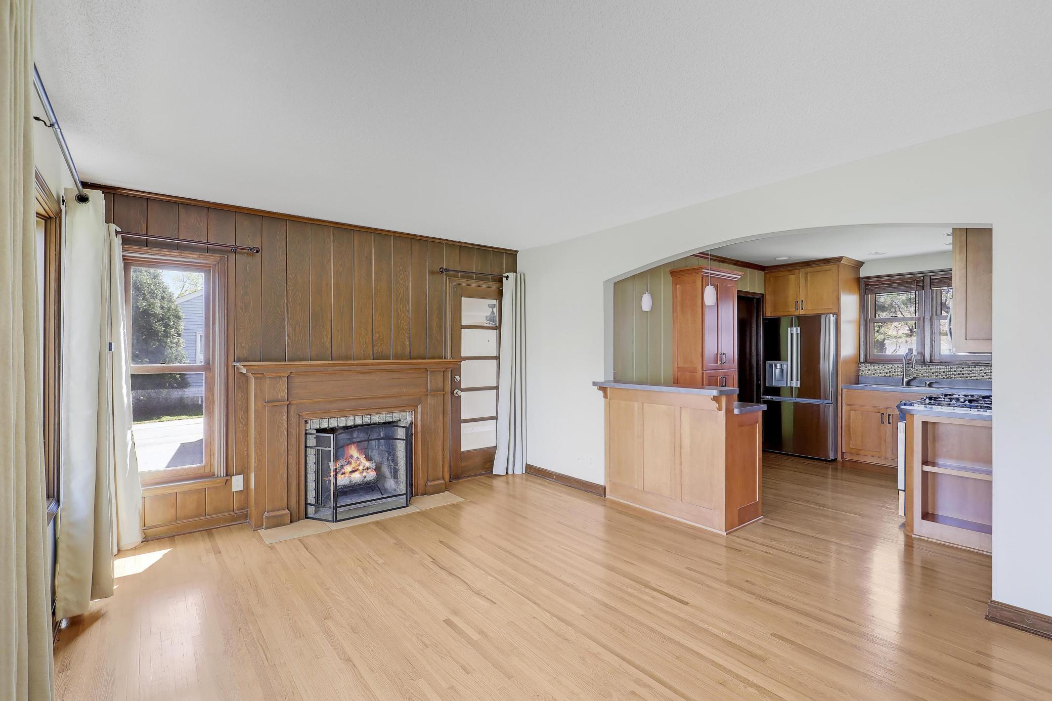 A central focus is this handsome fireplace and solid wood mantle.