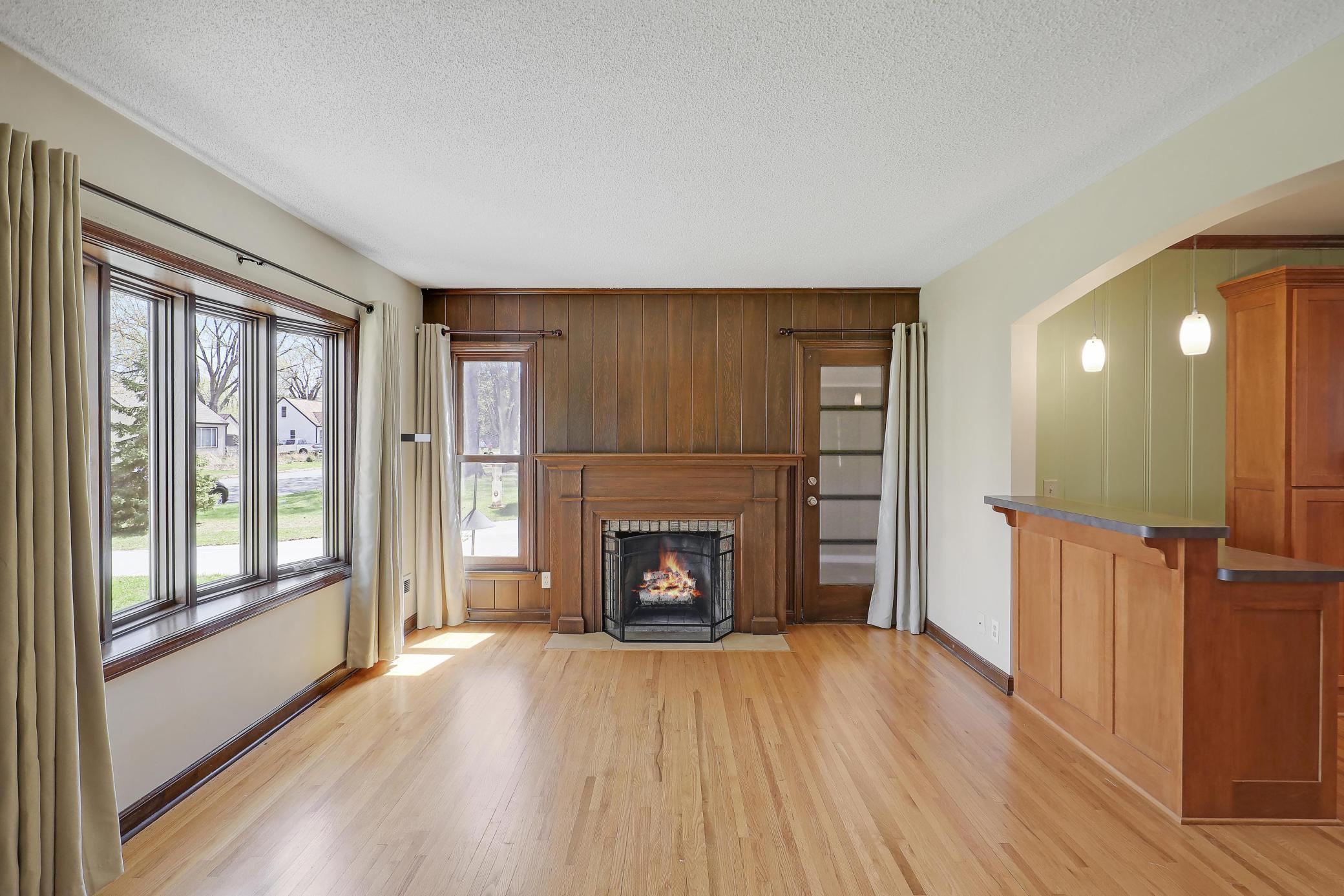 Living room features fine windows and doors. Verdant window treatments offer shade and privacy.