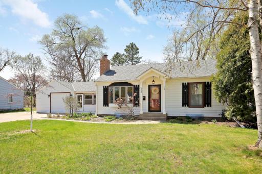 This little white house has lovely curb appeal. A variety of perennials are blooming!