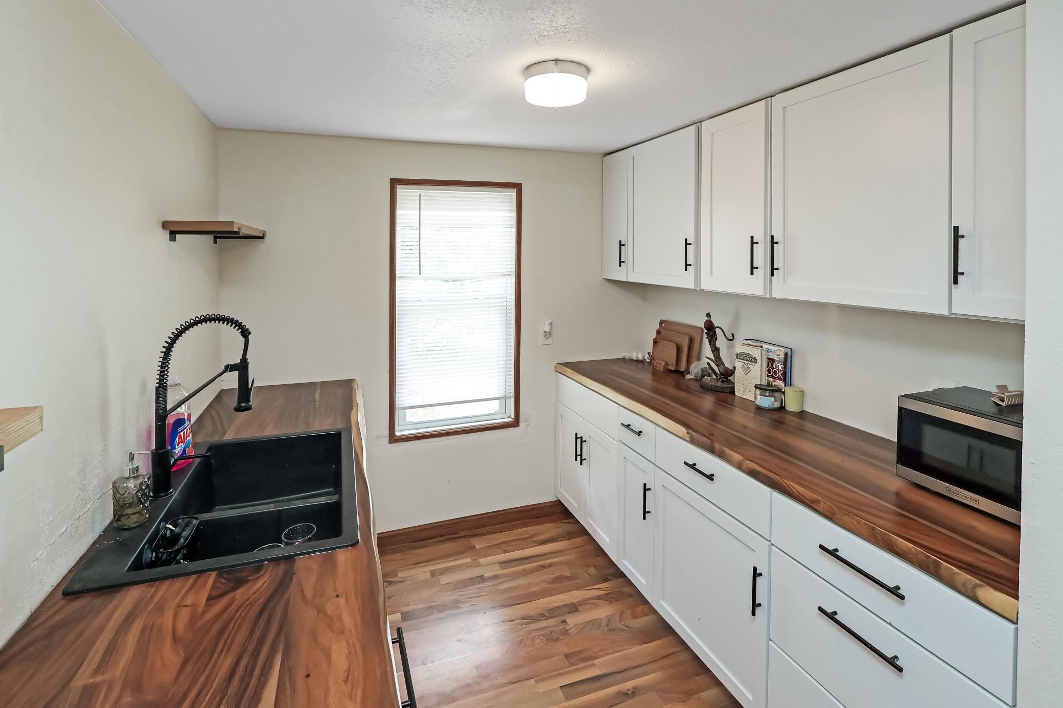 Updated kitchen with new countertops, cabinets and sink.jpg