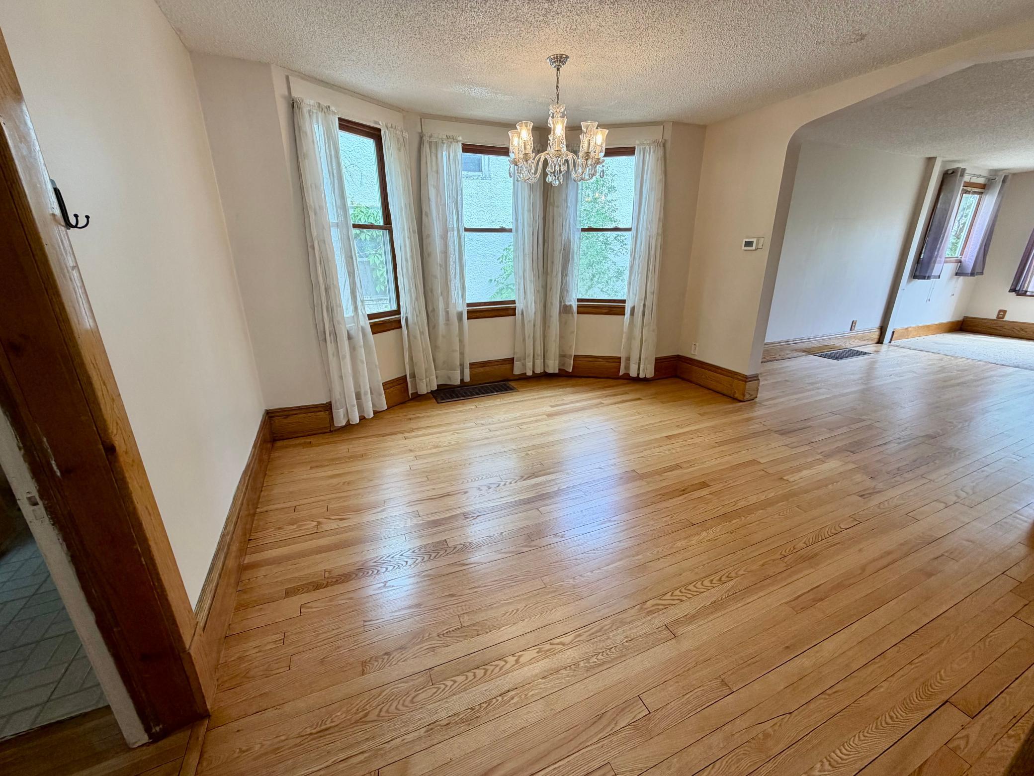 Large dining room with gorgeous hardwood floors.