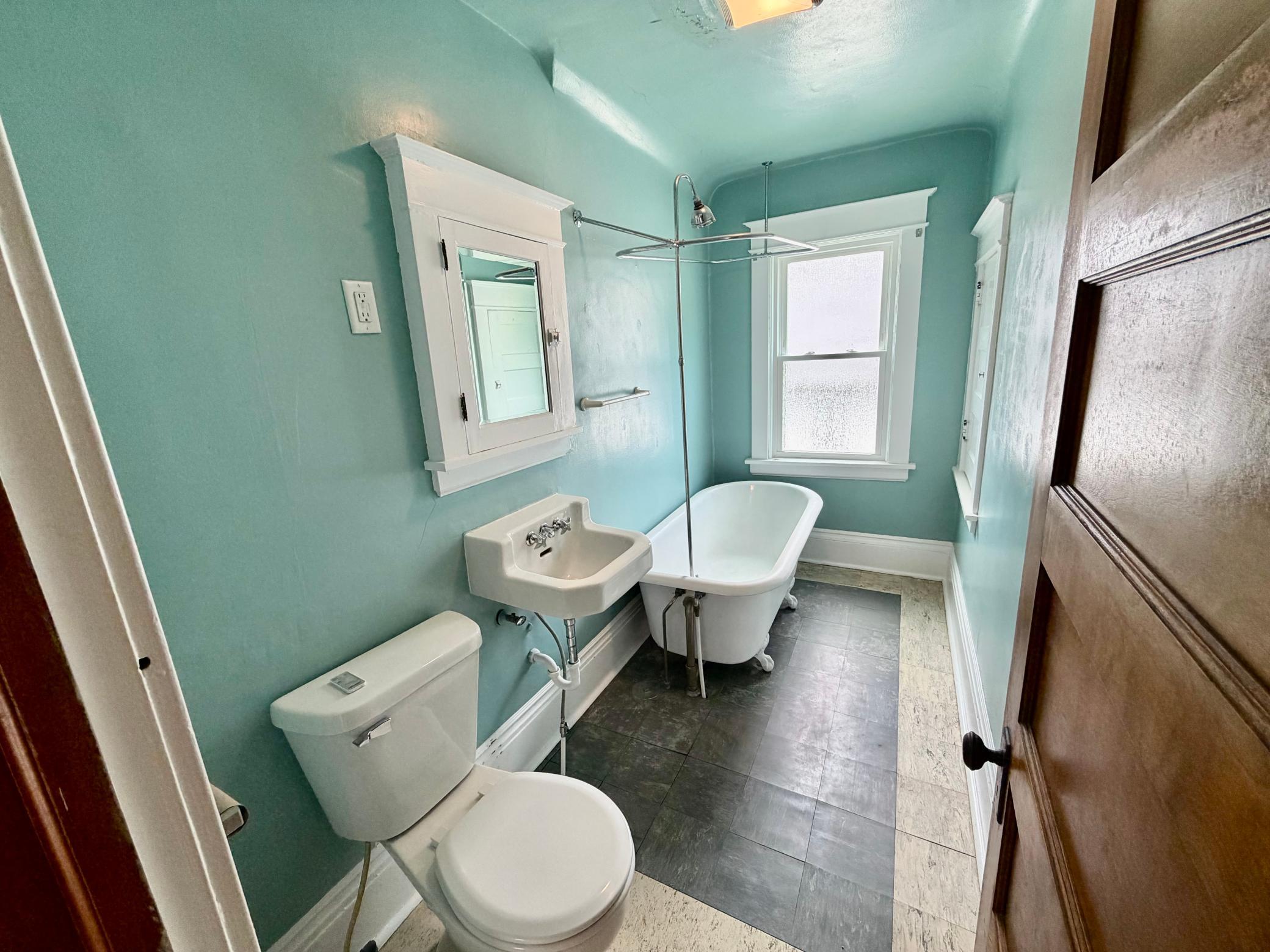 Upper level full bathroom with deep, clawfoot tub.
