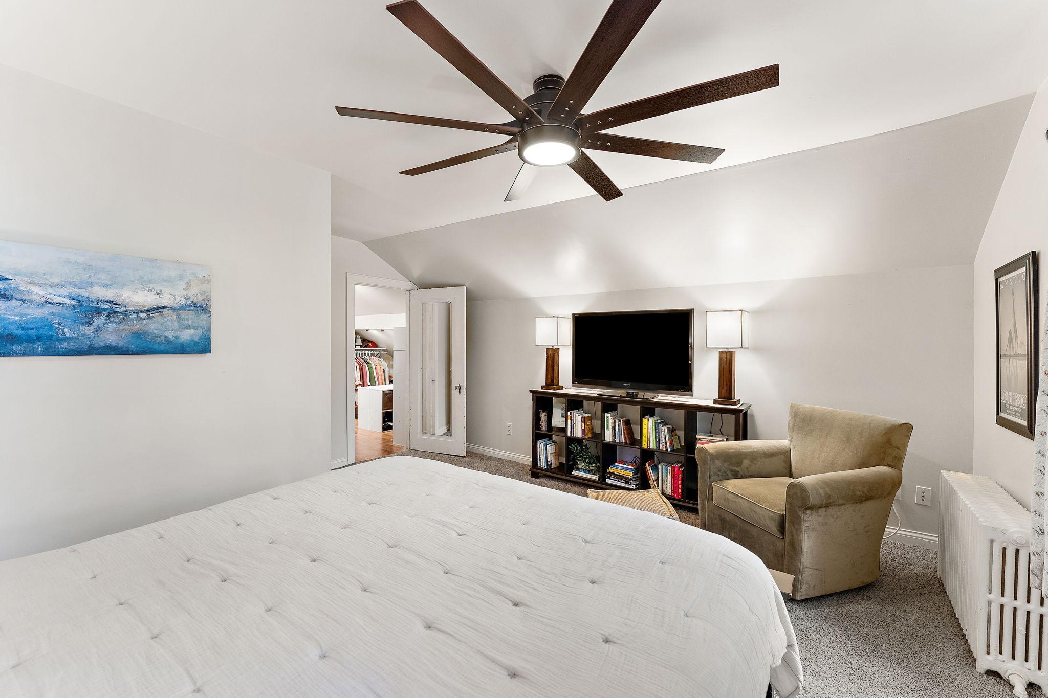 Spacious upper bedroom, sitting area, and a peak into the walk in closet