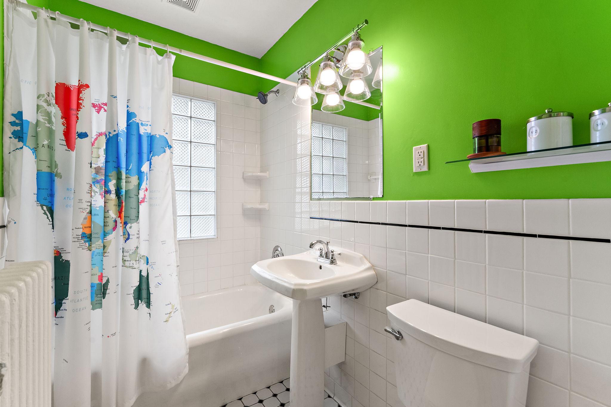Full bath with tiled shower and floors on the main level