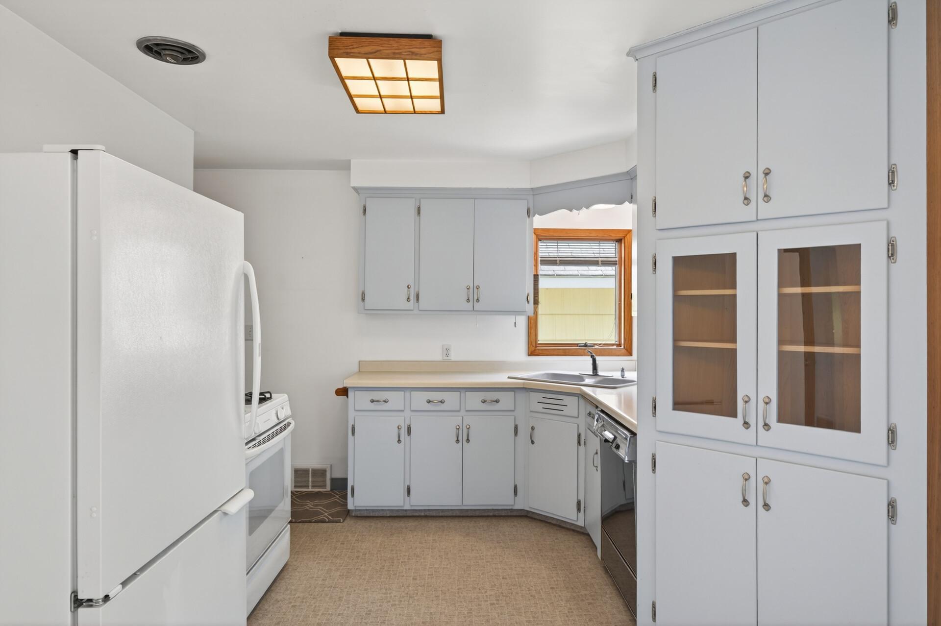 The kitchen offers lots of cabinets, dishwasher, stove and refrigerator.