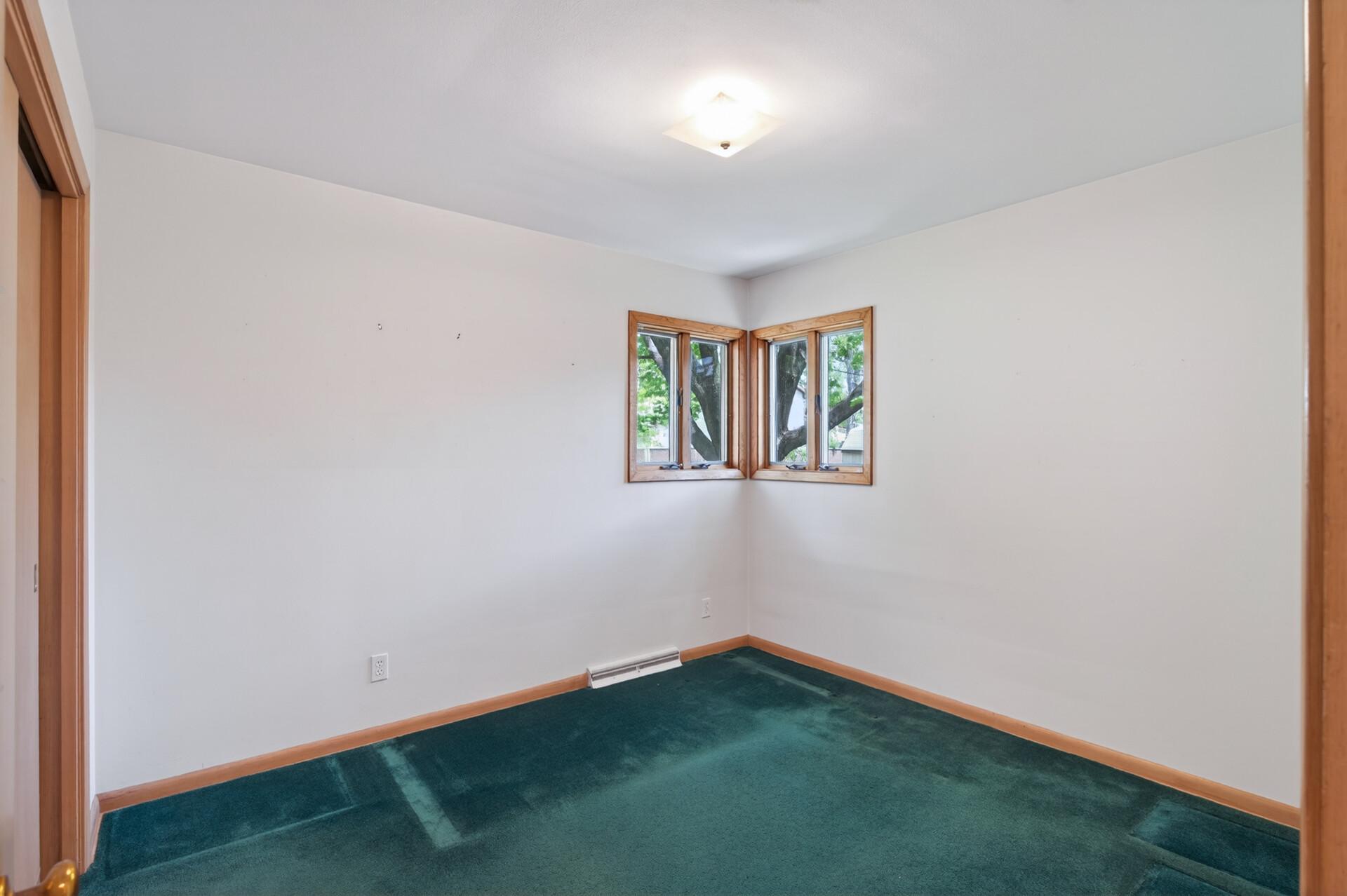 Bedroom # 2 on the main level with corner windows.