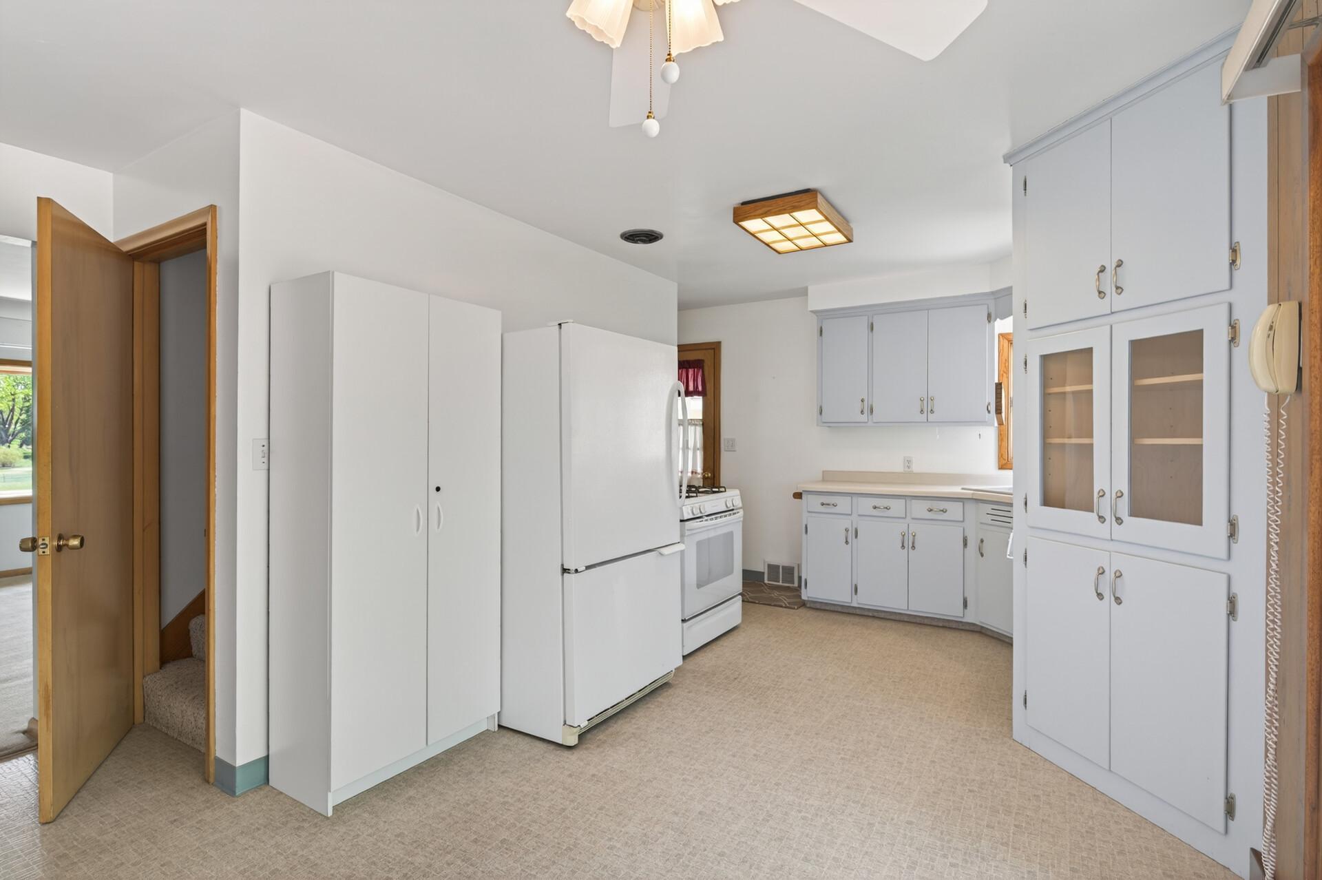 The door leads to the upper level off the kitchen.