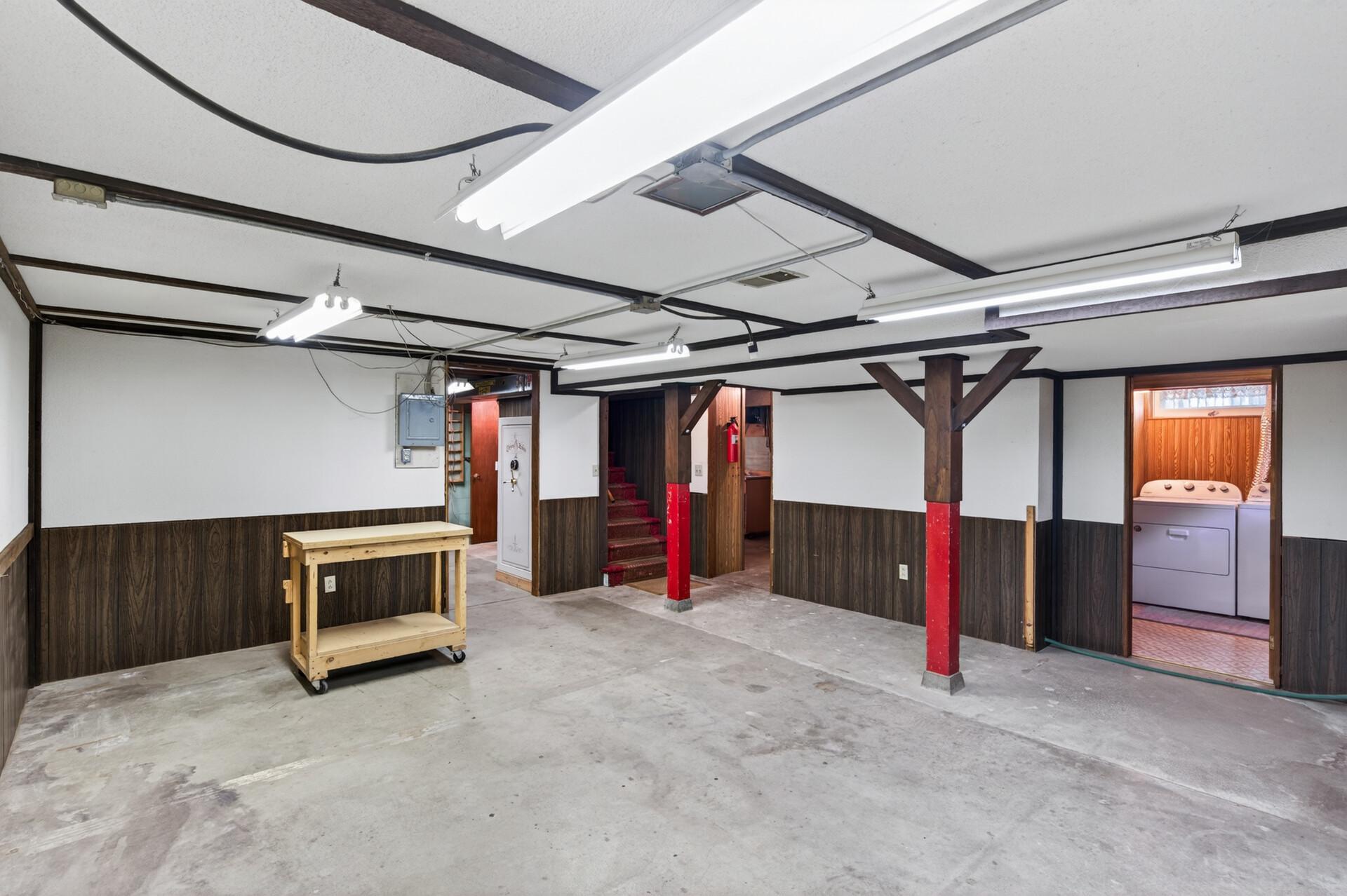 Another view of the basement space and a look into the laundry room and 1/2 bath.