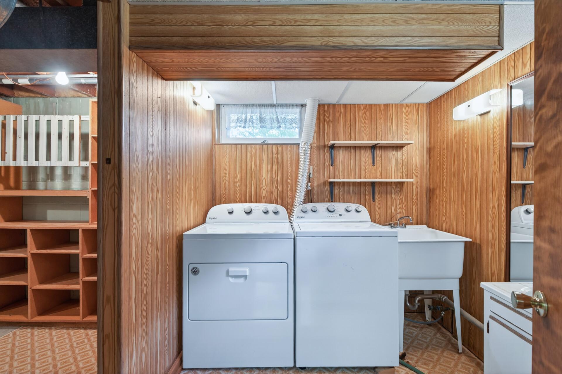 There is a finished laundry room with nice tub.