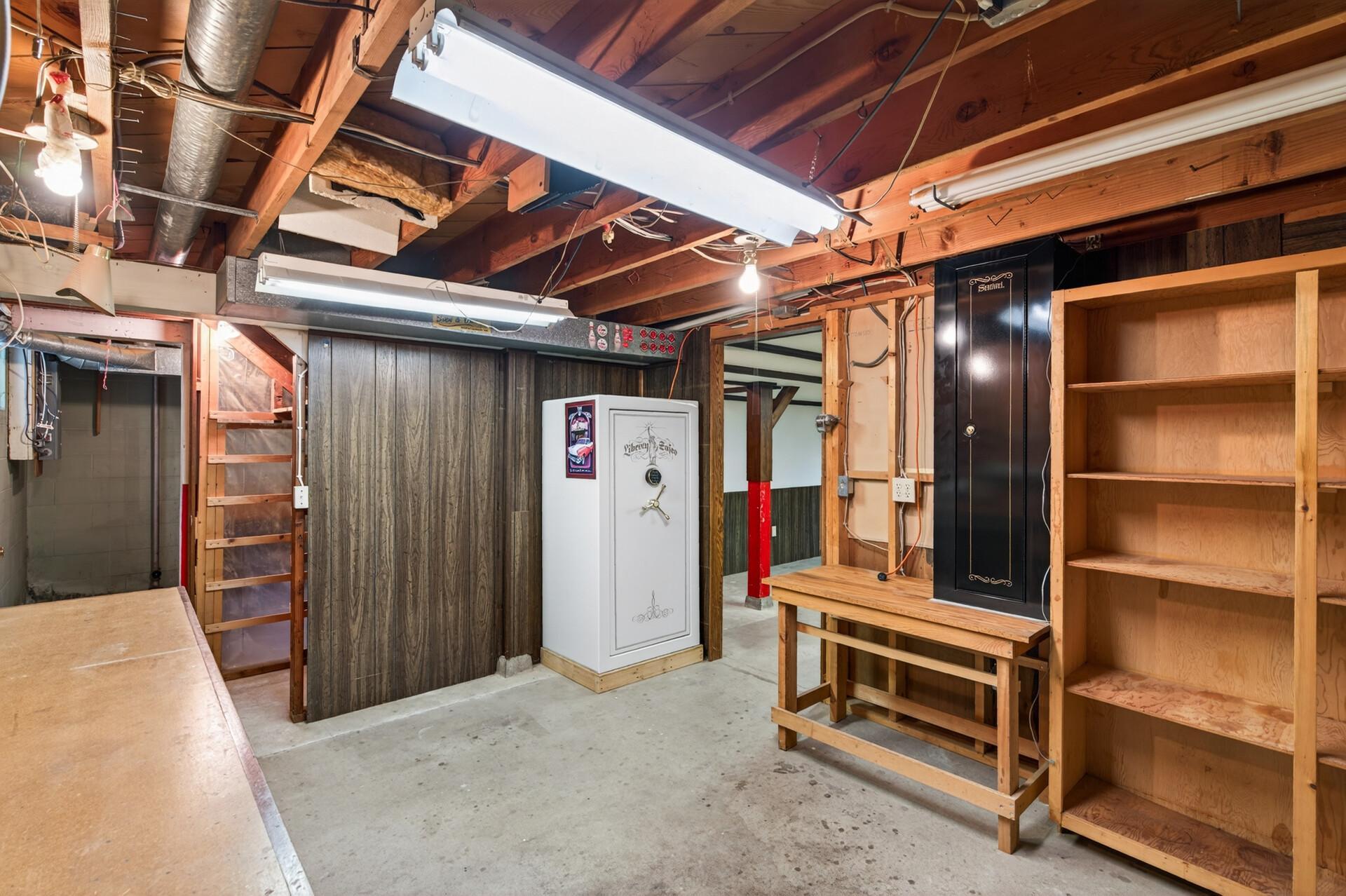 The workshop area with lots of shelving. The gun safe isn't included with the sale and will be removed by the closing.
