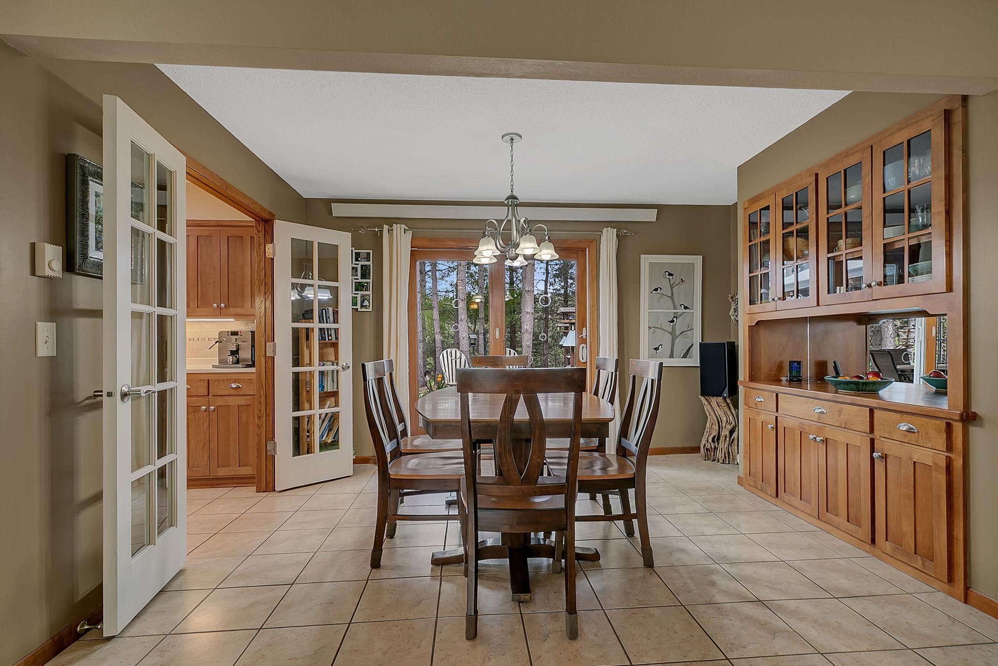 Dining Room offers built in buffet cabinets and french doors to the kitchen