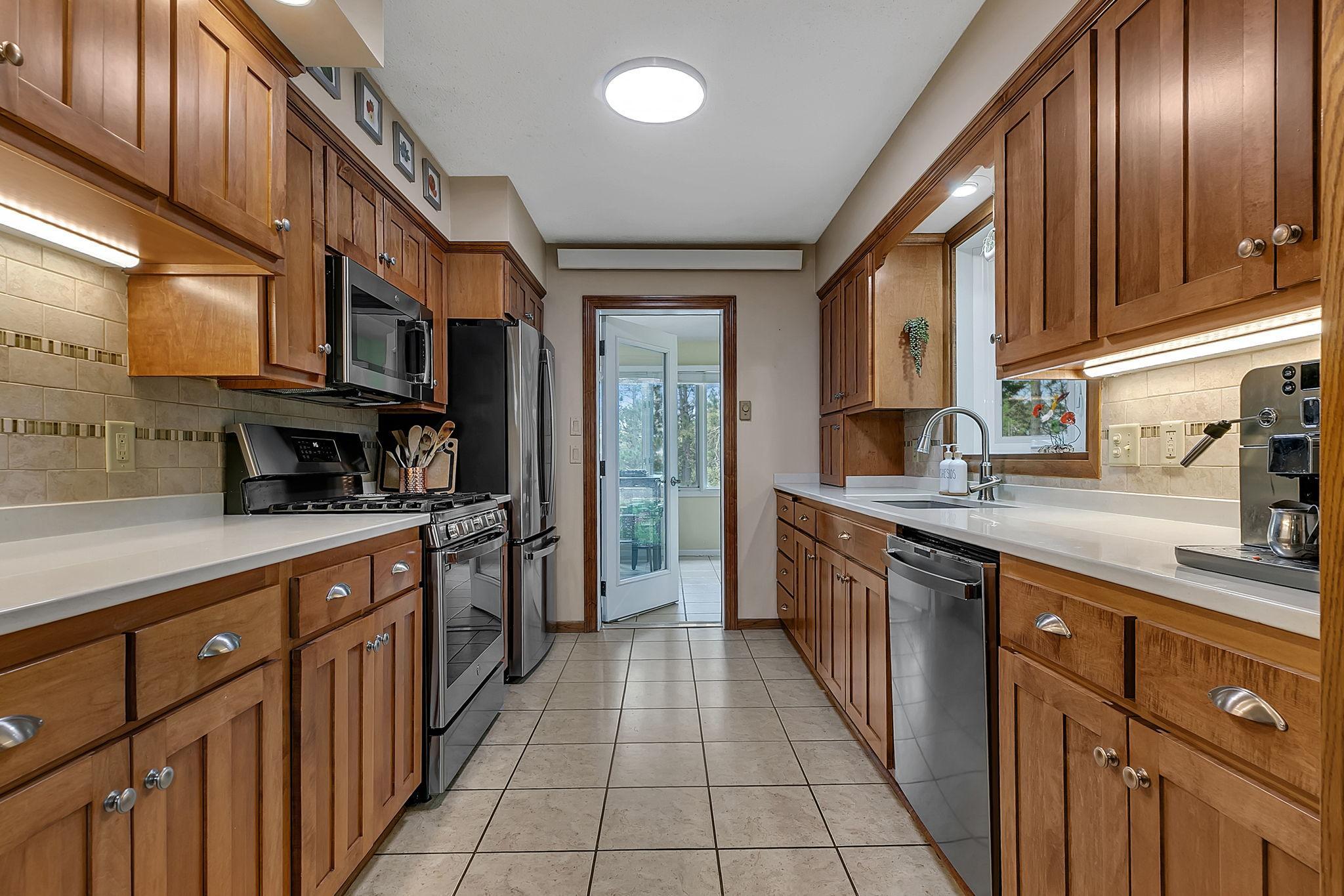 Kitchen accesses Sunroom and pool deck for convenient entertaining!