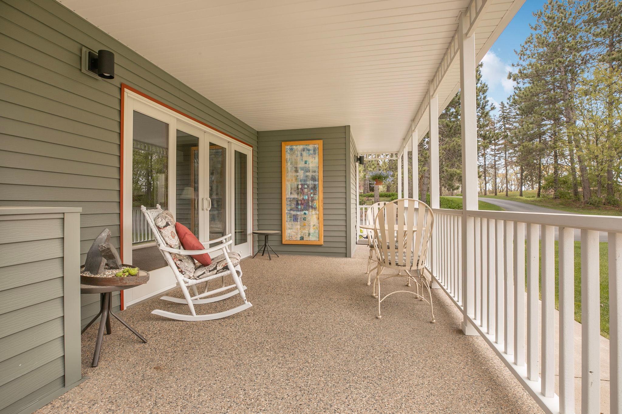 An inviting covered front porch made for enjoying hot afternoons!