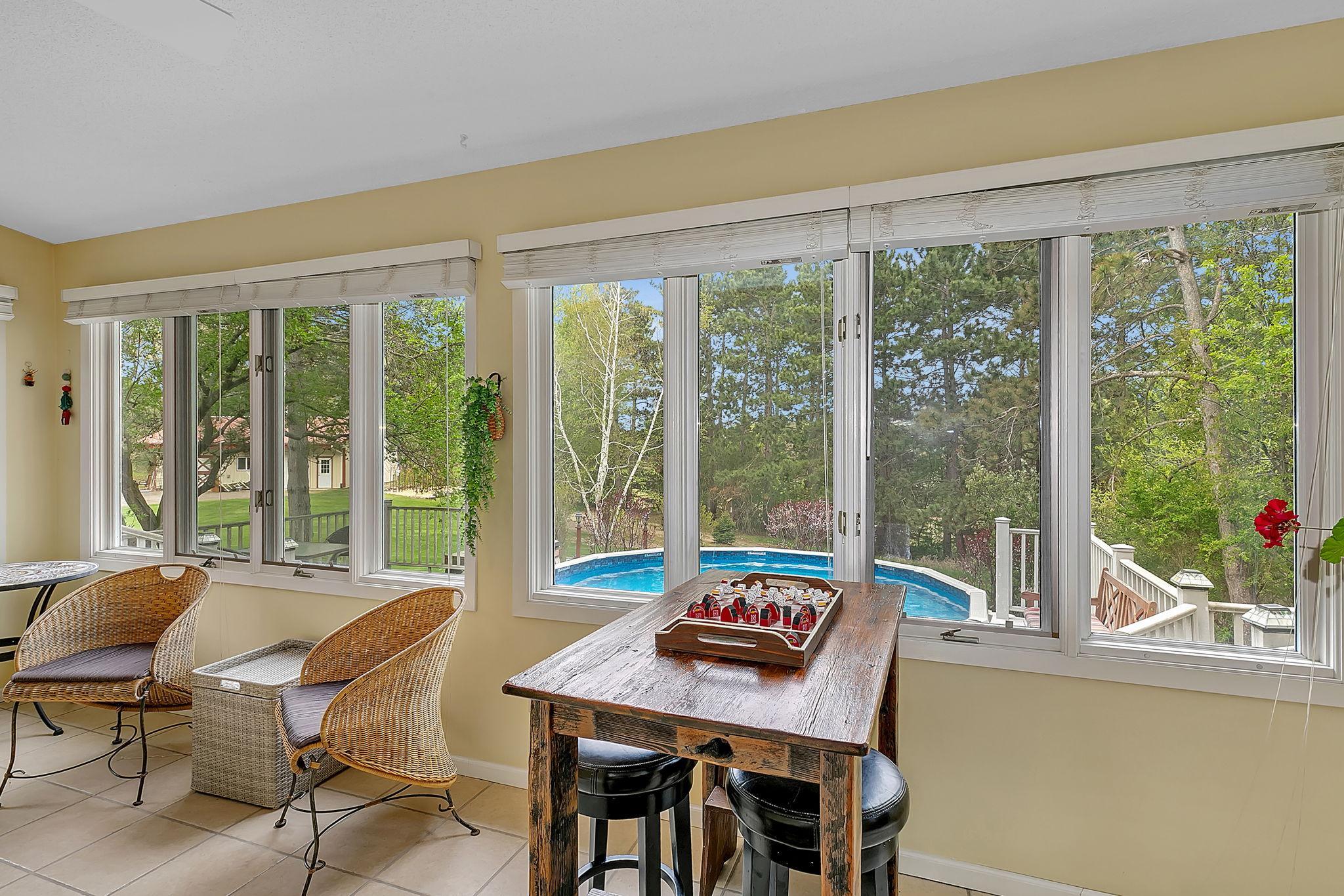 Looks out to pool deck and yard