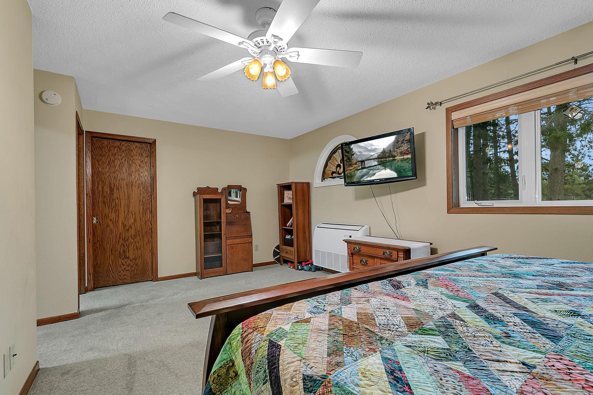 Alternate view of large primary bedroom with generously sized walk in closet