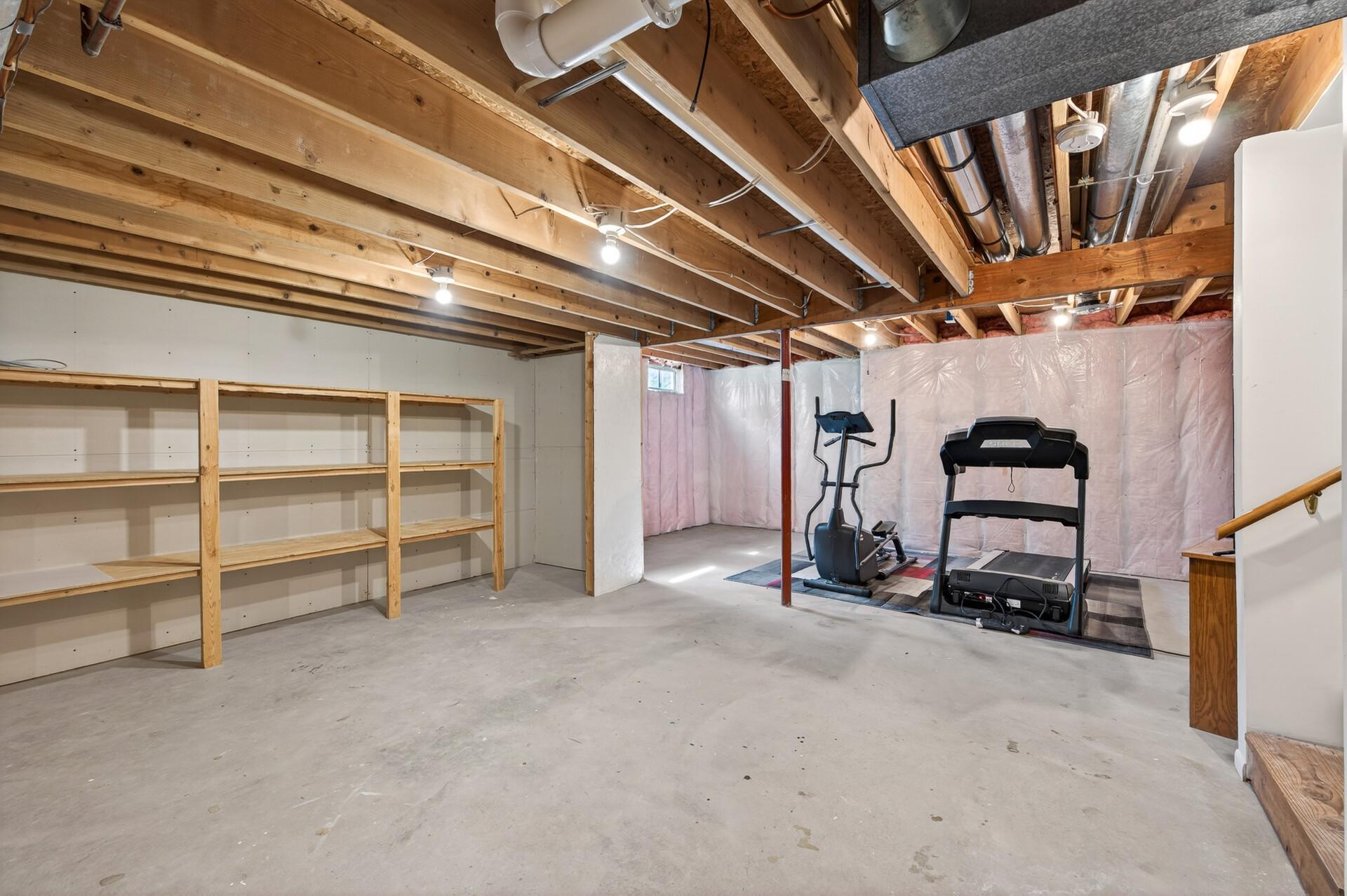 Unfinished basement area is ready for additional living space.