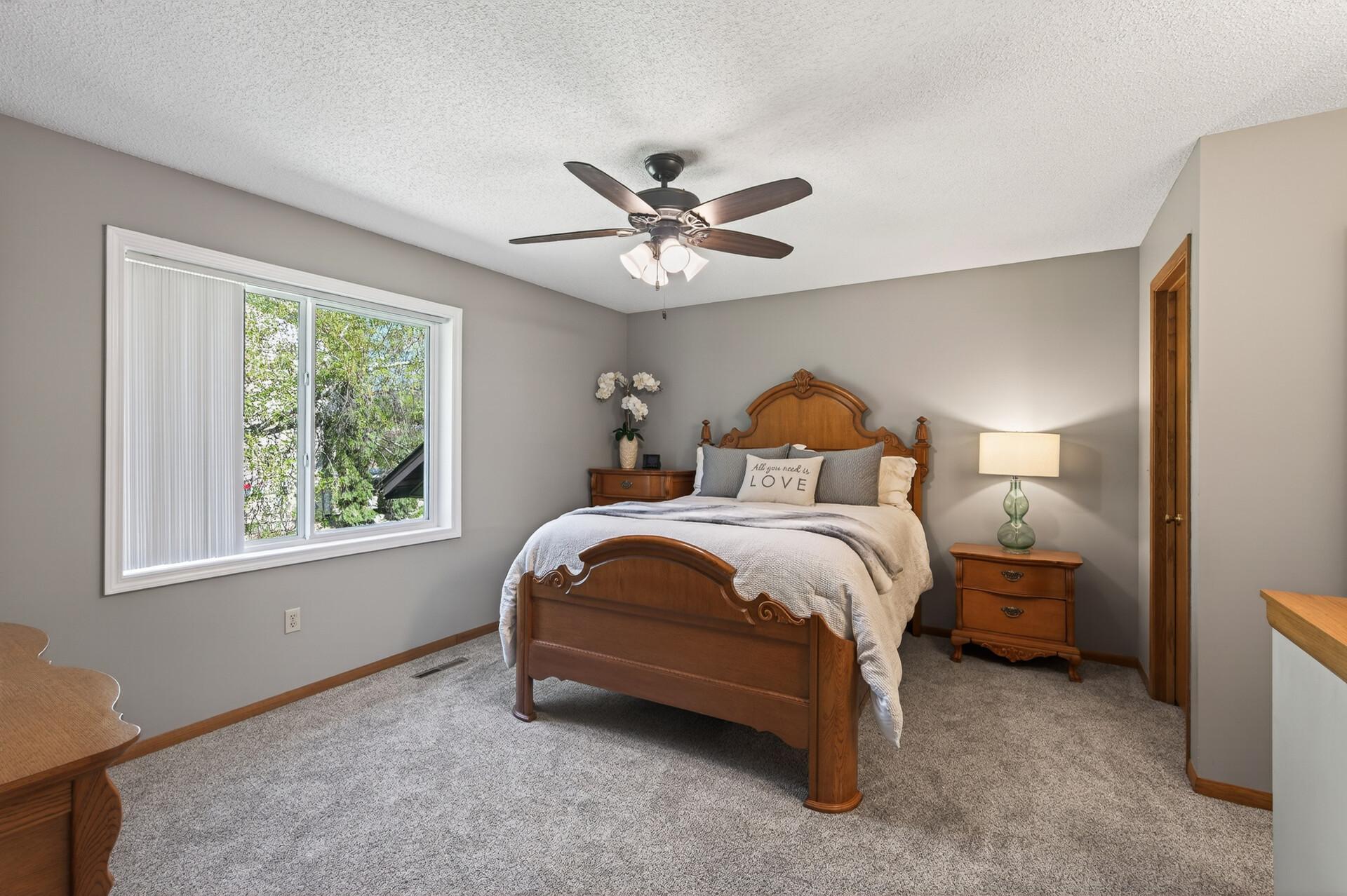 Spacious owners suite features a walk-in closet, and new floor coverings.