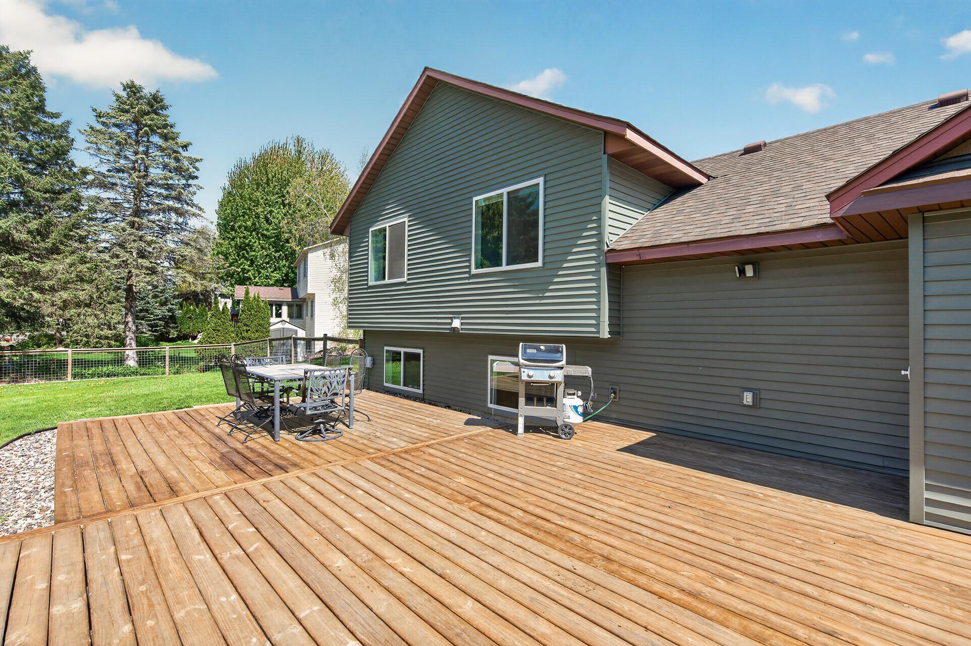 Huge back deck walks out to flat, 1/2 acre fenced yard.